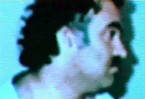 Khalid Shaikh Mohammed shortly after arrest. (Note: this picture is from a video presentation on prisoners the Pakistani government gave to BBC filmmakers. It has been adjusted to remove some blue tinge.)